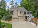 Charming home highlighting a two-car garage, inviting staircases, and beautiful landscaping for an appealing facade at 3278 Winter Wood Ct, Marietta, GA 30062