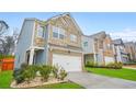 Two-story home with a stone and brick facade and an attached two-car garage at 826 Bentley Dr, Fairburn, GA 30213