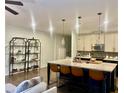 Kitchen with island and breakfast bar, stainless appliances and sleek pendant lights at 257 Stone Park Dr, Woodstock, GA 30188