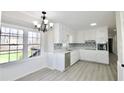 Bright eat-in kitchen with white cabinetry, quartz countertops, and stainless steel appliances at 2447 Old Peachtree Rd, Duluth, GA 30097