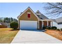 This home offers a well-manicured lawn, a two-car garage, and inviting curb appeal at 303 Dexter Dr, Woodstock, GA 30188