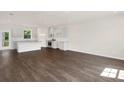 Bright living room with hardwood floors, an open kitchen, and lots of natural light at 320 Mahone Dr, Lilburn, GA 30047