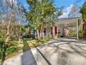 Charming home with an attached carport and long driveway nestled amongst mature trees at 46 W Belle Isle Rd, Atlanta, GA 30342