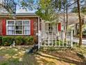 Quaint home with red shutters, white trim, and a welcoming front porch and carport at 46 W Belle Isle Rd, Atlanta, GA 30342