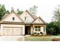 Beautiful home featuring a landscaped front yard and a spacious driveway at 5745 Pickens Garden Ln, Powder Springs, GA 30127