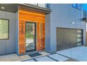 Striking front entrance features a wood accent wall, modern black door, and a spacious two-car garage at 548 Fletcher St, Atlanta, GA 30310
