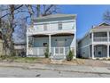Charming two-story home featuring a welcoming front porch and an upper-level balcony, perfect for enjoying outdoor living at 73 Atlanta Sw Ave, Atlanta, GA 30315