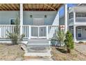 Close-up of a charming front porch with a gated entrance, small trees, and steps leading to the home's front door at 73 Atlanta Sw Ave, Atlanta, GA 30315