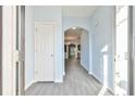 Bright foyer with wood-look flooring, neutral walls, and an arched doorway leading to living spaces at 1526 Viero Dr, Lawrenceville, GA 30044