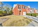 Inviting two-story brick home with a well-kept lawn and driveway, providing ample parking space at 1526 Viero Dr, Lawrenceville, GA 30044