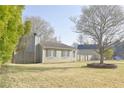 Cozy home with a spacious yard, chimney, and wooden fence offers a charming curb appeal at 10375 Plantation Bridge Dr, Johns Creek, GA 30022