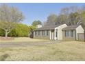 Quaint single-story home displays lovely landscaping and a well-manicured lawn on a sunny day at 10375 Plantation Bridge Dr, Johns Creek, GA 30022