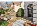 Stone walkway leading to an elegant doorway and manicured landscaping at 1056 Shady Valley Ne Pl, Brookhaven, GA 30324