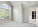Spacious bedroom with a large window and neutral walls and carpet at 1909 Sawgrass Dr, Hampton, GA 30228