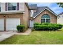 The home's brick facade and manicured front yard enhance curb appeal at 1909 Sawgrass Dr, Hampton, GA 30228