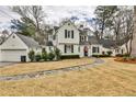 Charming two-story home with white brick, black shutters, an American flag, and a well-maintained front lawn at 2885 Alpine Ne Rd, Atlanta, GA 30305