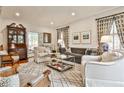 Bright living room features hardwood floors, custom curtains, and an antique hutch with French doors at 2885 Alpine Ne Rd, Atlanta, GA 30305