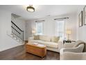 Cozy living room featuring hardwood floors, a light sofa, and natural light from large windows at 1101 Collier Nw Rd # V3, Atlanta, GA 30318