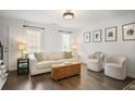 Bright living room featuring hardwood floors, a light sofa, and natural light from large windows at 1101 Collier Nw Rd # V3, Atlanta, GA 30318