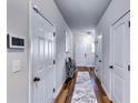 Inviting hallway with light gray walls, wood-look floors, and multiple doors at 1709 Creel Ln, Atlanta, GA 30349