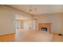 Spacious living room with a classic brick fireplace, hardwood floors and a ceiling fan at 2410 Deep Shoals Cir, Decatur, GA 30034