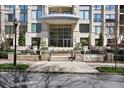 Luxury building entrance with beautiful landscaping and street view at 3445 Stratford Ne Rd # 2504, Atlanta, GA 30326