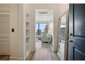 Bright hallway with hardwood floors, shelving, and city views through large windows at 3445 Stratford Ne Rd # 2504, Atlanta, GA 30326