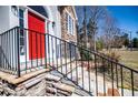 Stone steps with black railing lead to a red front door, highlighting the house's curb appeal at 4638 Arrow Wind Dr, Powder Springs, GA 30127