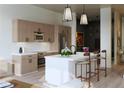 Contemporary kitchen boasts sleek cabinetry, stainless steel appliances, a large island, and pendant lighting at 567 Ponce De Leon Ne Ave # 404, Atlanta, GA 30308