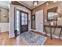 Welcoming entryway with hardwood floors, elegant console table, and decorative mirror at 1009 Fairway Seven, Villa Rica, GA 30180
