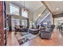 Bright and airy living room with high ceilings, fireplace, and staircase at 1009 Fairway Seven, Villa Rica, GA 30180