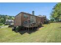 Beautiful backyard and deck of a spacious home with mature trees, offering privacy and shade at 6016 Southland Dr, Stone Mountain, GA 30087