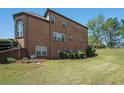 Spacious backyard with lush green grass and mature trees, perfect for outdoor activities at 6016 Southland Dr, Stone Mountain, GA 30087
