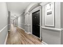 Long hallway with neutral paint, white trim, and wood-look flooring leading to unit 1008 at 1850 Cotillion Dr # 1008, Atlanta, GA 30338