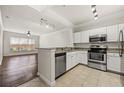 Bright kitchen featuring white cabinets, stainless steel appliances, granite countertops, and tile floor at 1850 Cotillion Dr # 1008, Atlanta, GA 30338