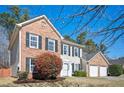 Charming two-story brick and siding home with a well-manicured lawn and attached two-car garage at 3090 Perch Overlook Sw, Marietta, GA 30008