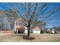 Charming two-story brick and siding home with a well-manicured lawn and attached two-car garage at 3090 Perch Overlook Sw, Marietta, GA 30008