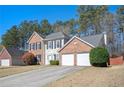 Charming two-story brick and siding home with a well-manicured lawn and attached two-car garage at 3090 Perch Overlook Sw, Marietta, GA 30008