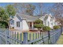Charming one-story home featuring a welcoming front porch, black fence and well-maintained landscaping at 1627 Walker Ave, College Park, GA 30337