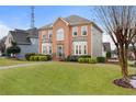 A classic two-story brick house with neat front yard and manicured shrubs at 2605 Jacobean Rd, Acworth, GA 30101