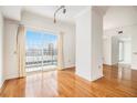 Bright living room with hardwood floors, balcony access, and neutral paint at 195 14Th Ne St # Ph 306, Atlanta, GA 30309