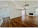 Bright living room featuring hardwood floors, a ceiling fan, fireplace, and natural light at 2695 Lindsey Oak Ln, Lawrenceville, GA 30044