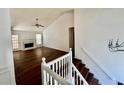 The living room showcases hardwood floors, a fireplace, natural light and direct access to stairs at 2695 Lindsey Oak Ln, Lawrenceville, GA 30044