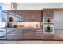 Contemporary kitchen featuring sleek wood cabinetry, stainless steel appliances, and modern finishes at 45 Ivan Allen Jr Nw Blvd # 1704, Atlanta, GA 30308