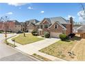 Charming brick home with a well-maintained lawn, spacious driveway, and attractive curb appeal at 50 Riverstone Dr, Covington, GA 30014