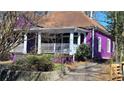 Eye-catching purple home features a inviting front porch at 885 White Sw St, Atlanta, GA 30310