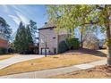 Spacious backyard featuring a deck, basketball hoop and ample space for outdoor activities at 3491 Falls Branch Ct, Buford, GA 30519