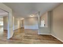 Open concept dining area with wood-look flooring and wainscoting at 4590 Carver Ct, Cumming, GA 30040