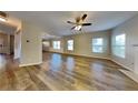 Spacious living room featuring wood-look flooring, many windows, and a ceiling fan at 4590 Carver Ct, Cumming, GA 30040