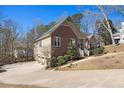 Beautiful home showcasing a three-car garage, with a brick and siding exterior, and well-manicured landscaping at 5395 Steeple Chase, Douglasville, GA 30135